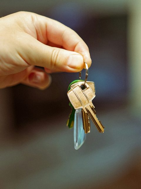 A person holding a bunch of keys in their hand